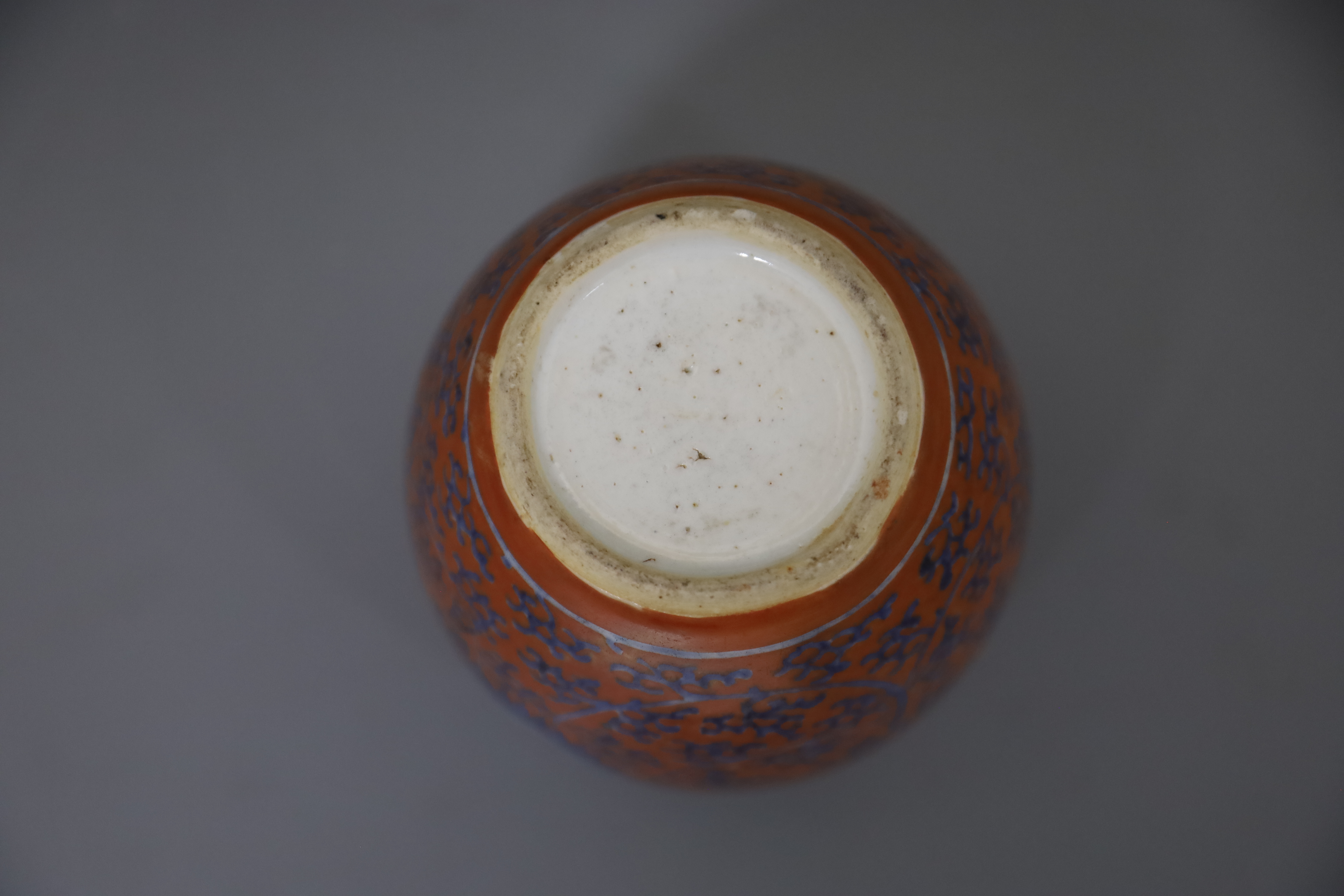 A Chinese coral red ground underglaze blue jar, Kangxi period, H. 12.3cm, excluding wood cover and stand